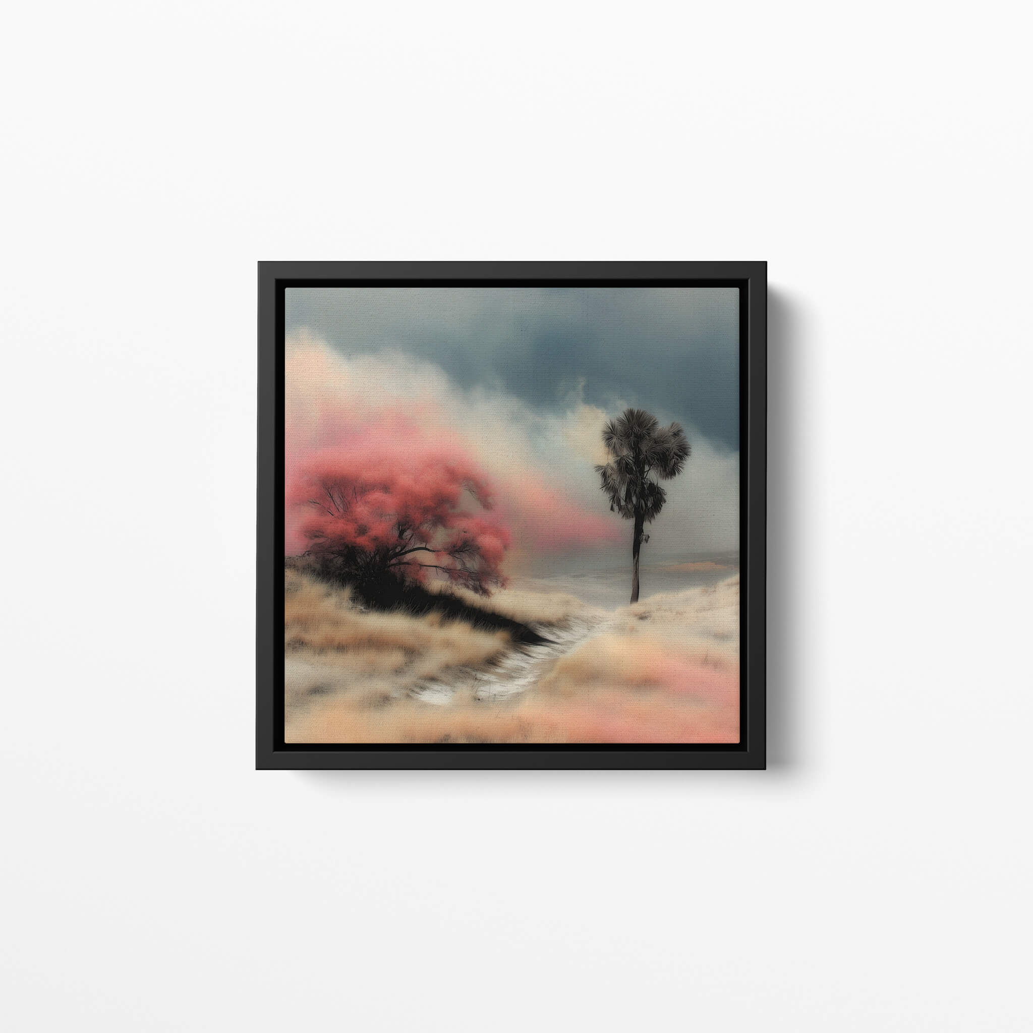 Framed art print artwork of a landscape with trees and pinkish-red sky on a white wall.