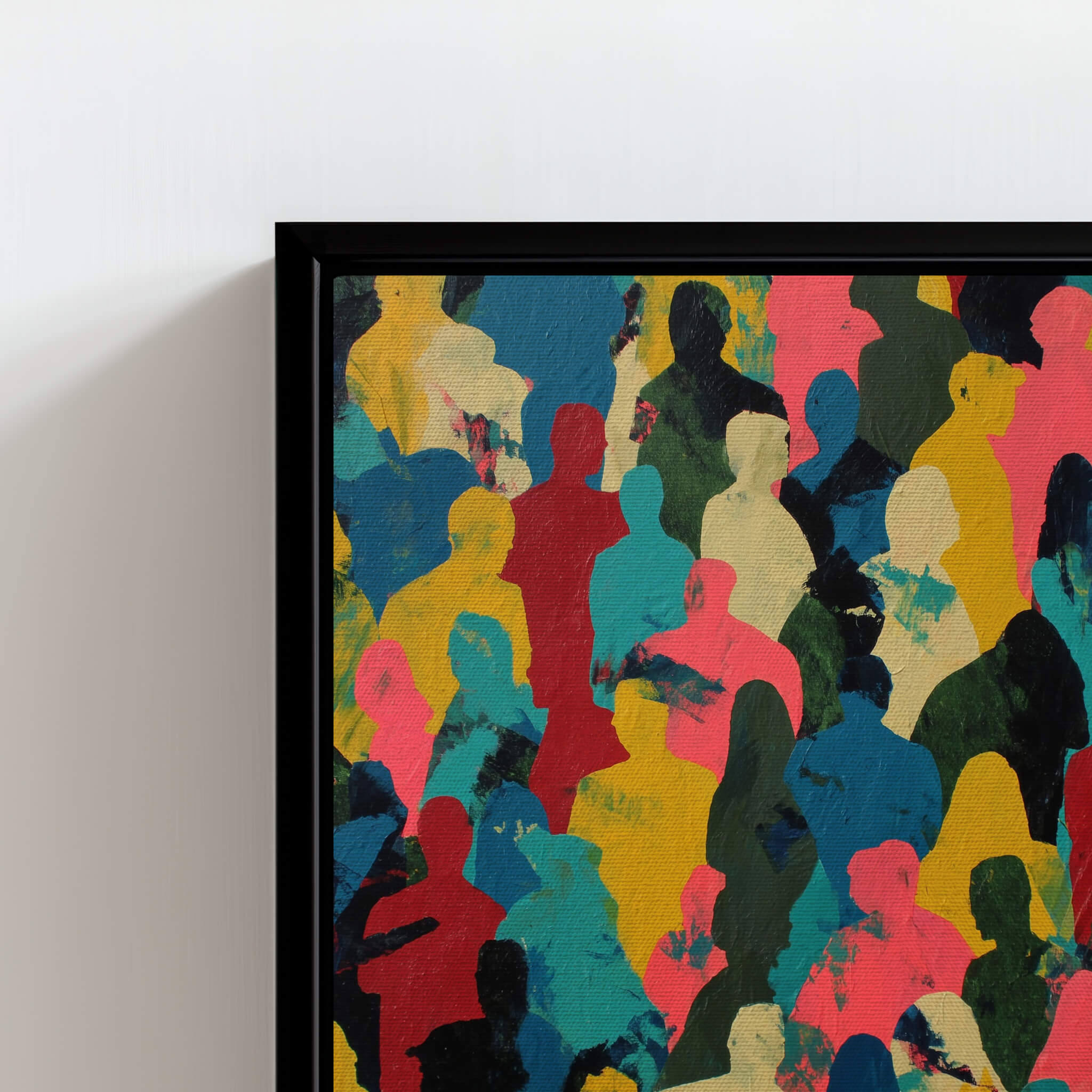 Framed abstract artwork with colorful silhouettes on a white wall