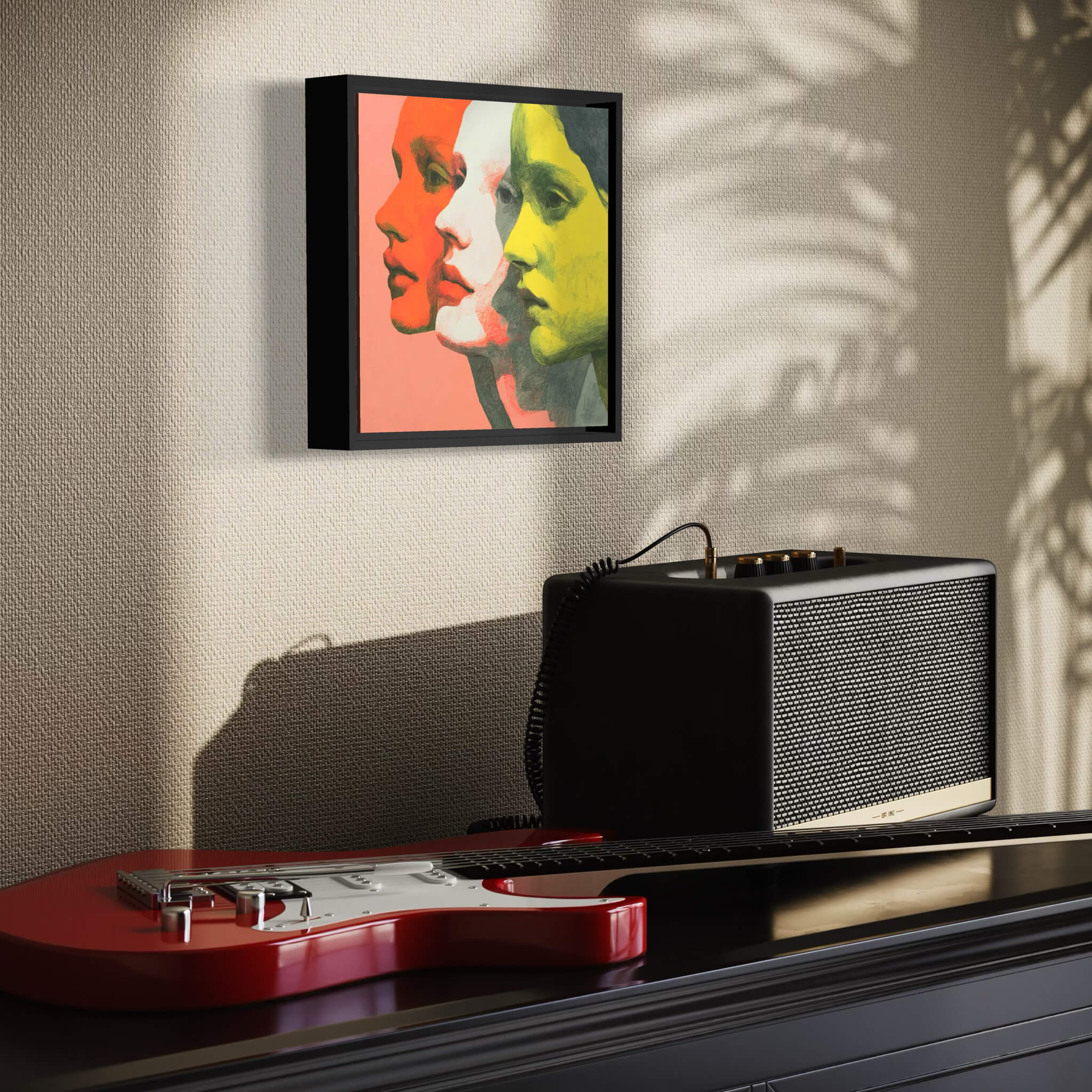 Guitar, amplifier, and framed artwork on a wall with a textured surface