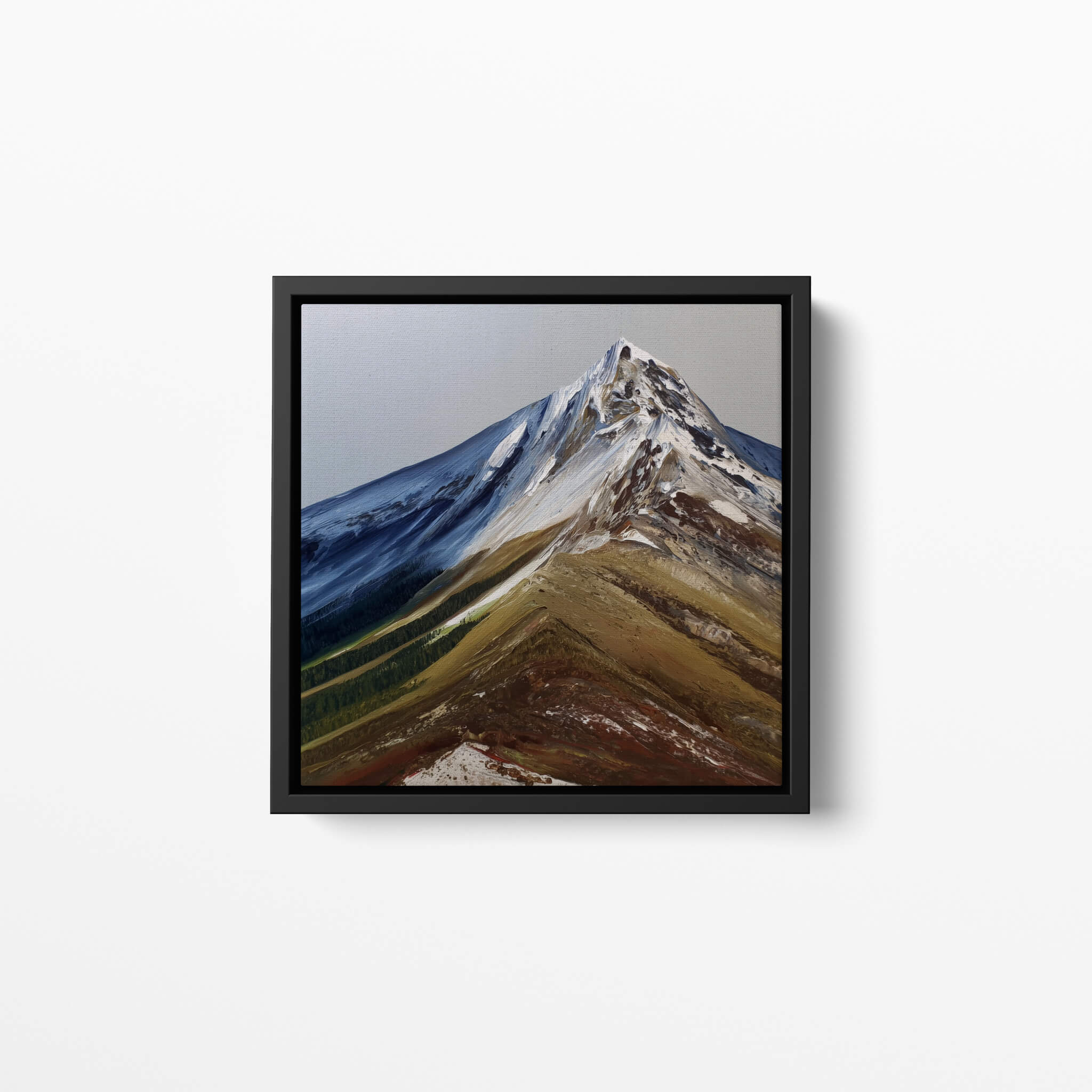 Framed fine art print of a mountain oil painting on a white wall