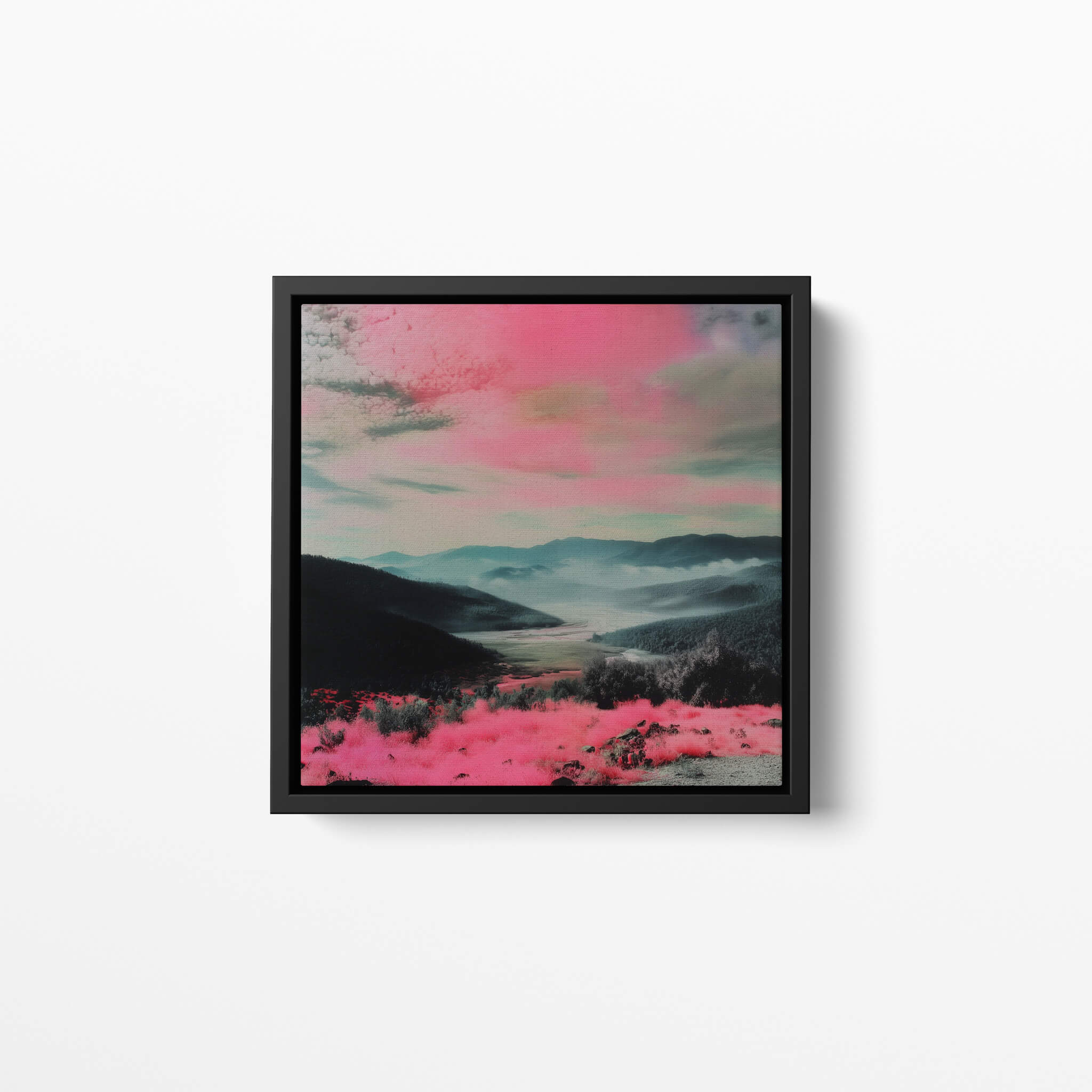 Framed artwork with a pink and blue landscape on a white wall