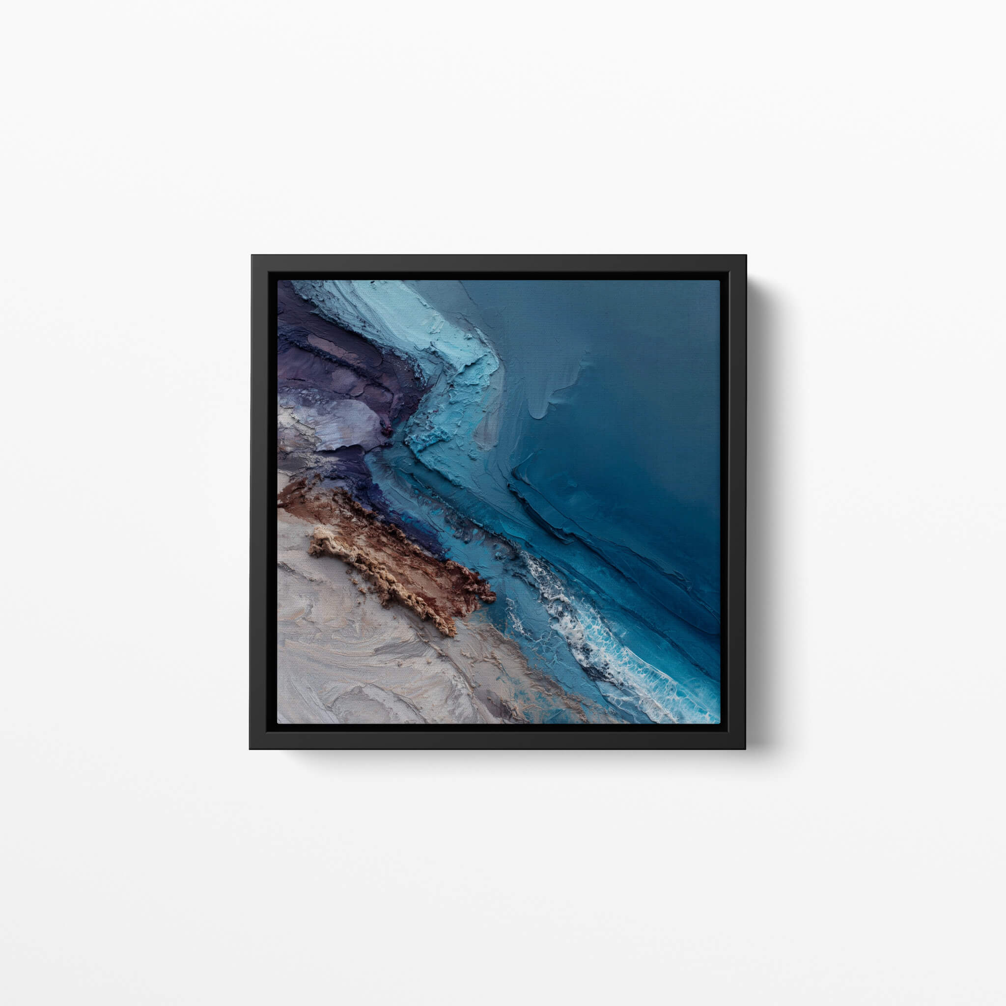 Framed abstract artwork with blue and brown tones on a white wall