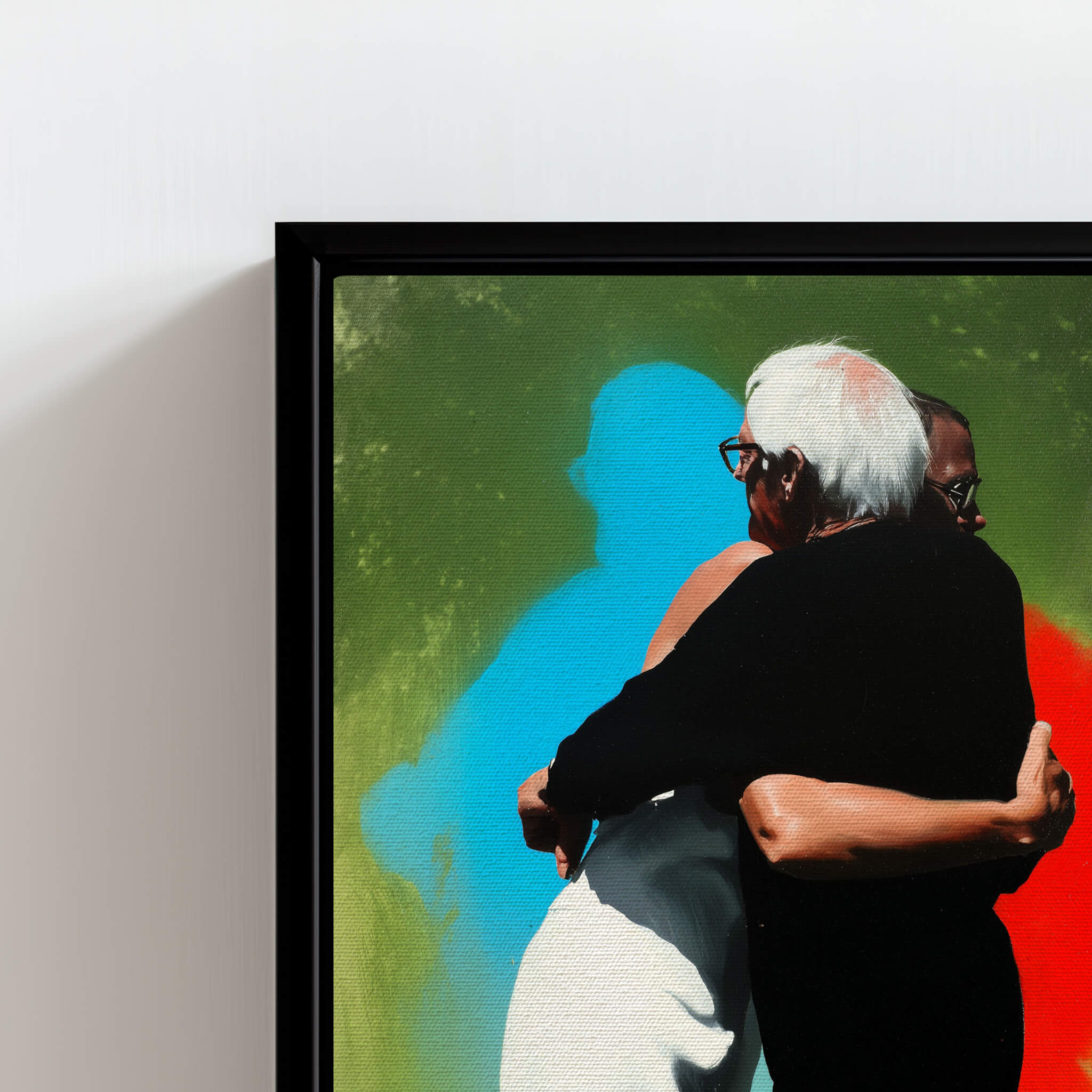 Framed artwork of two people embracing with a colorful abstract background