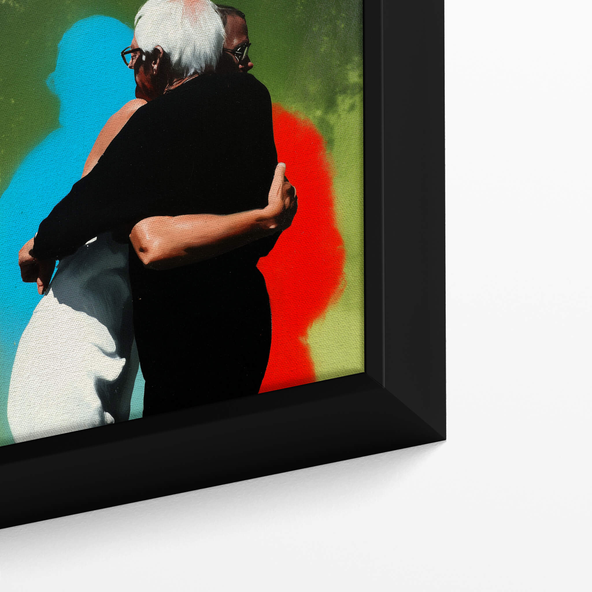 Framed artwork of two people embracing with colorful abstract shapes in the background.