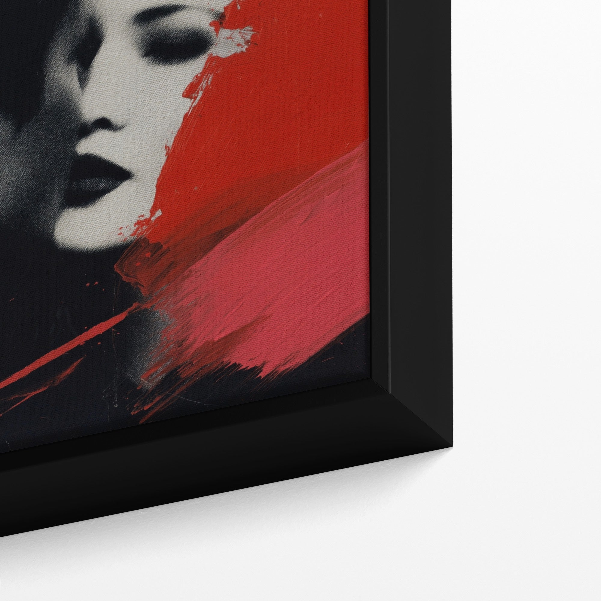 Framed artwork with a stylized face design featuring red and black colors.