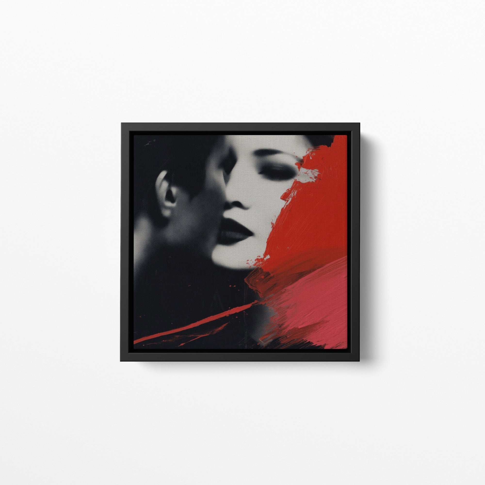 Framed artwork of a stylized portrait with red and black abstract elements on a white background
